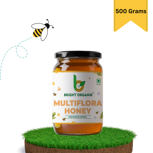 multiflora honey in a 500 grams jar on grass top and honey bee flying nearby